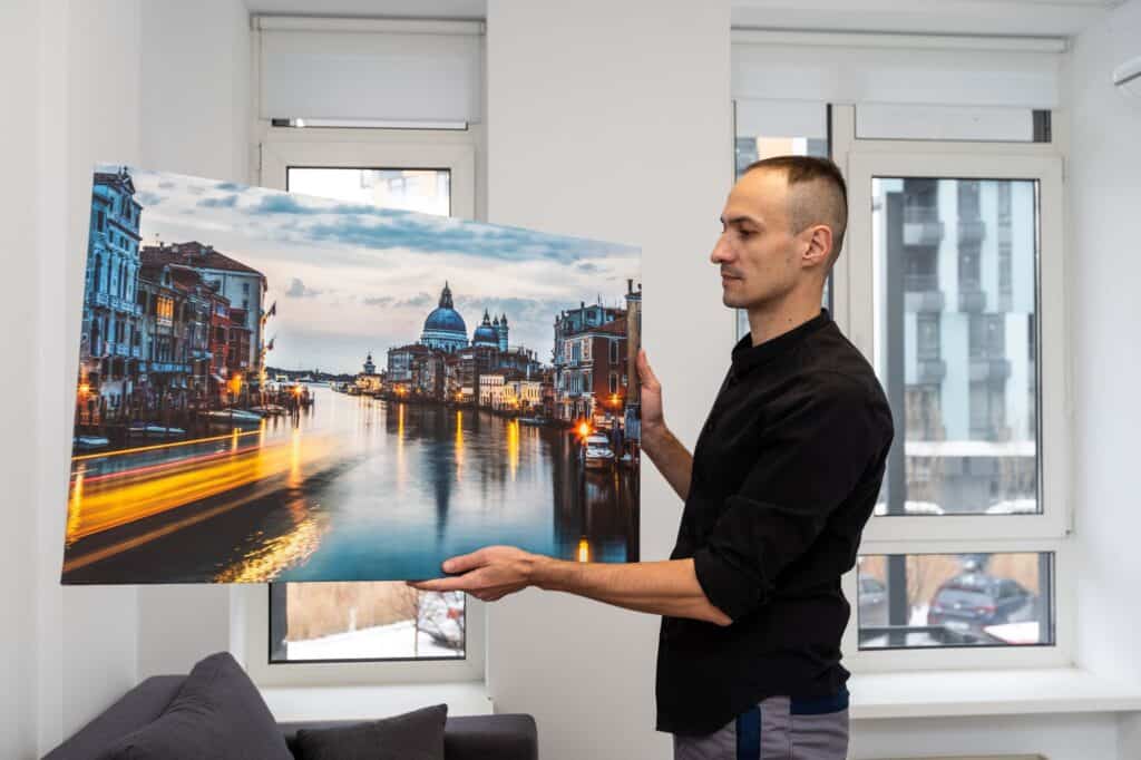 A man holding a canvas print