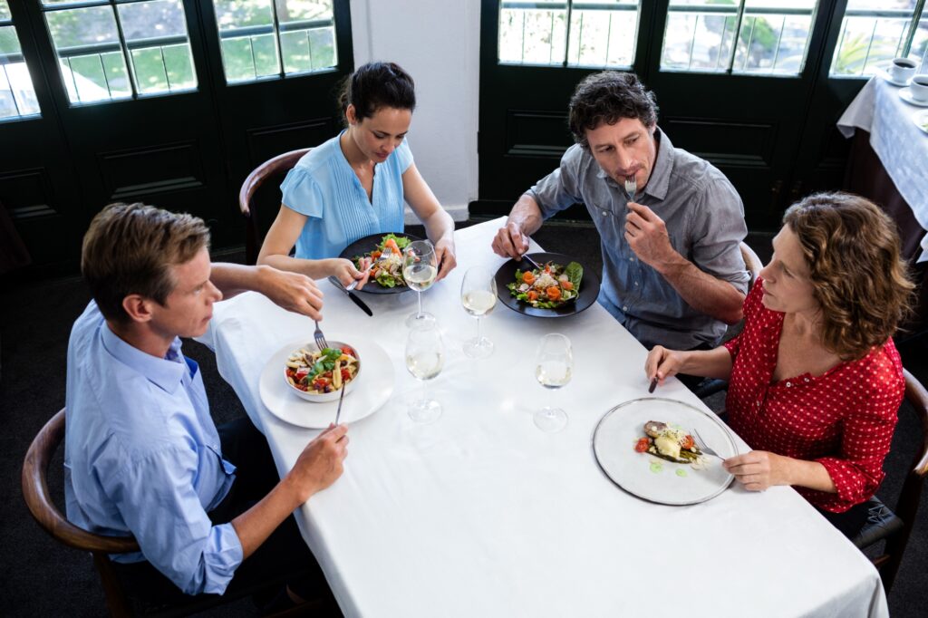 A group of friends talking about the house move while having lunch