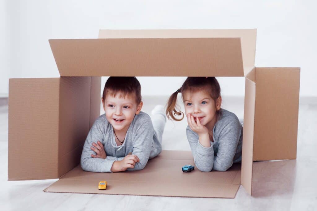 Kids playing under a box